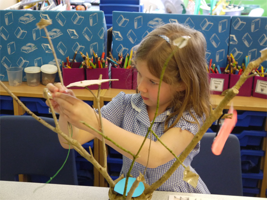 Sticks secured in pots and then "dressed" with inventive treehouse elements