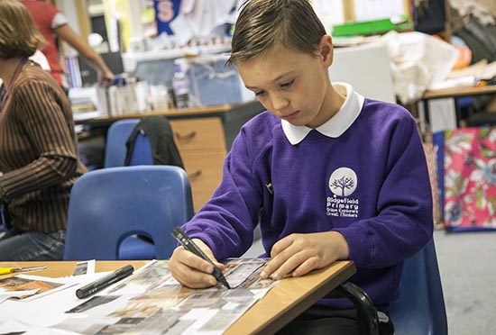 Pupil traces over his collage in acetate with a permanent marker