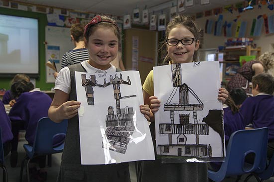 Pupils hold up their traced images