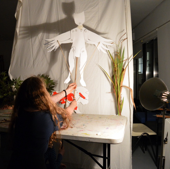 Teenager at AccesArt's Experimental Drawing Class preforming in the shadow puppet play