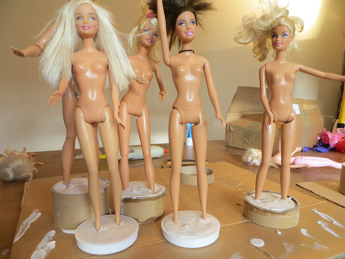 Barbies standing in plaster bases
