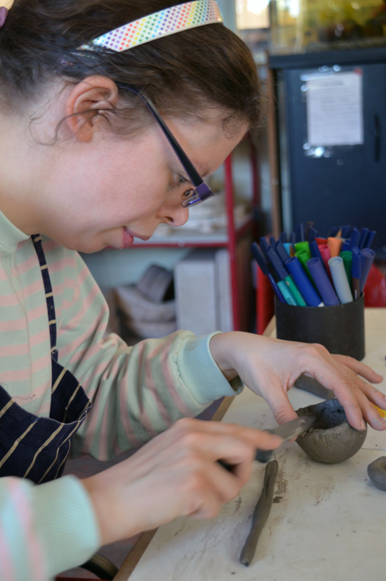 Rosie scores her clay coil before applying the next coil layer and builds up Tweety Pie