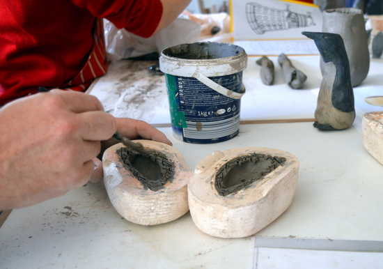 Mark had scored the clay on both halves of the mould before painting on the clay slip