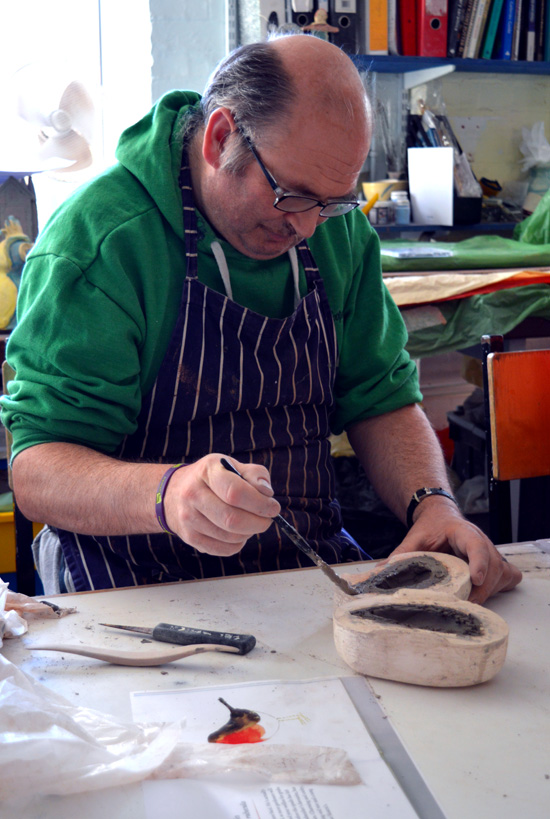 Mark paints slip onto clay to join the two parts together
