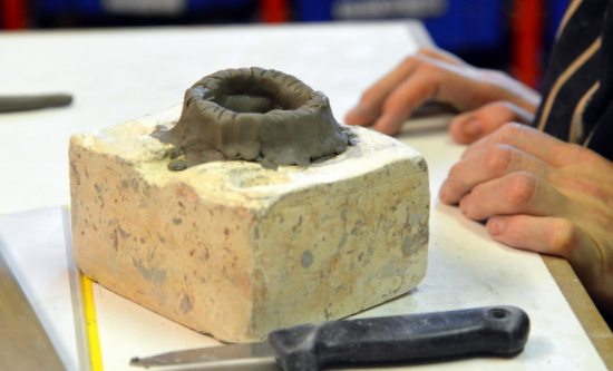 Clay base still in the mould and the start of Emma's bird with coiling techniques