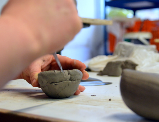 Emma scores the surface between each coil layer