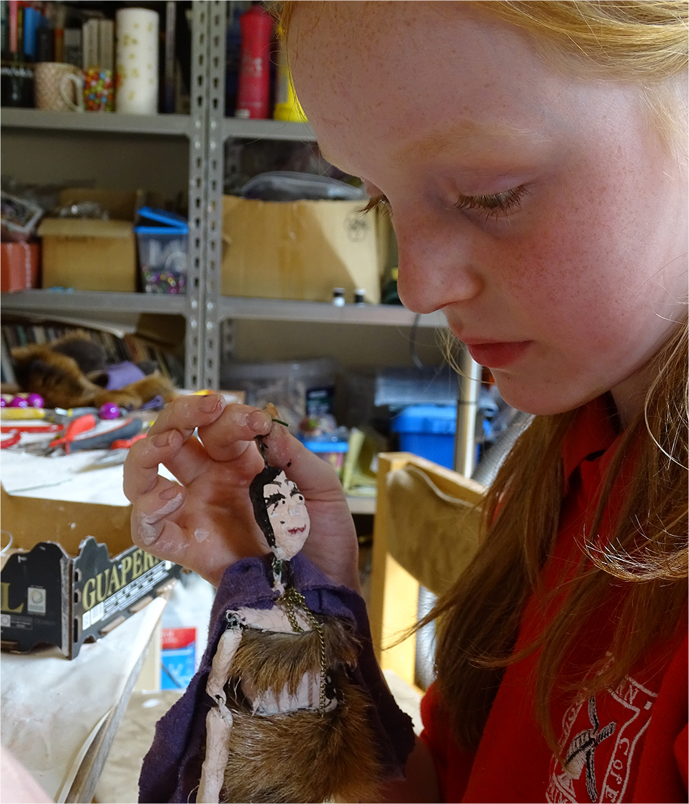 So cute - look at the way the doll is staring adoringly at it's maker!