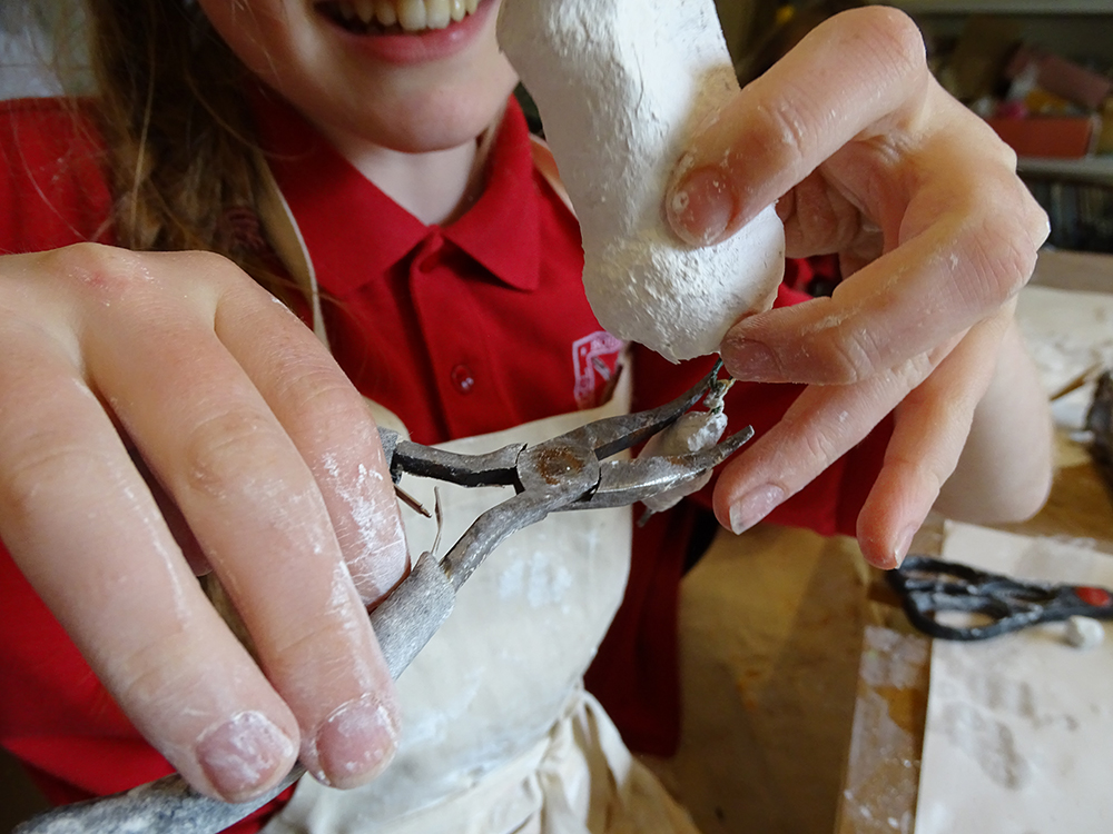 Once the pieces are set, use pliers to bend the wires into hoops. Feed each limb into a hoop, and again use the pliers to secure