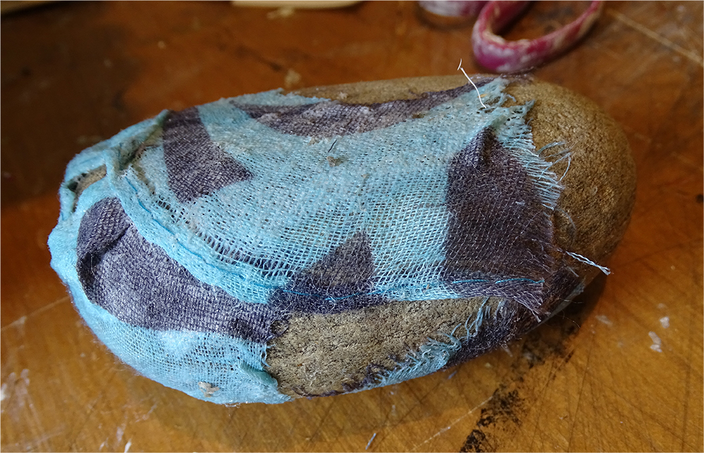 We covered large pebbles in fabric