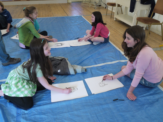 Using charcoal dust and hands to create portraits from observation.