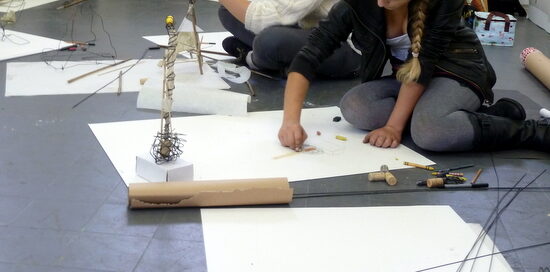 Teenagers build structures with wire and sticks in Drawing Space Teenagers build structures with wire and sticks in Drawing Space