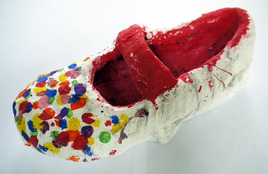 Building a sculptural shoe around old shoes, using modroc and paint.