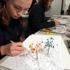 Student working - Drawing feeding making - tree growing from the paper - on the wall