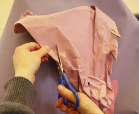 Construction based workshop in which children learn to manipulate paper into 3-d forms to create a costume.