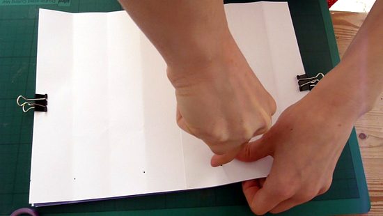 Making a hole through pages with an awl