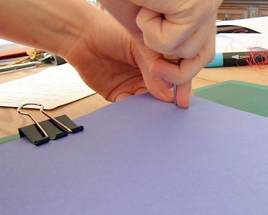 Making holes through front and back covers of the book