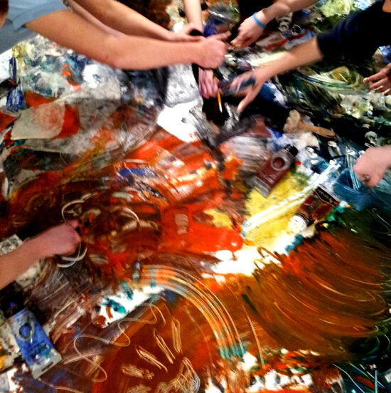 Group painting activity: girls battle it out with paint