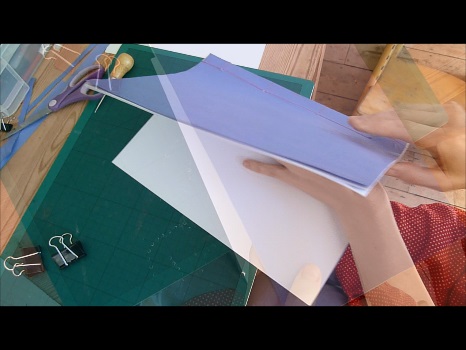 Snapshot from video of Aurora finding the other end of the thread in the second hole in the middle of the book