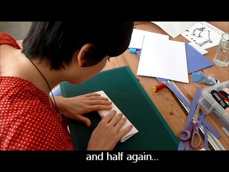Screen shot from the video above of Aurora folding the template again