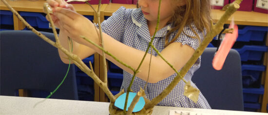 Sticks secured in pots and then "dressed" with inventive treehouse elements
