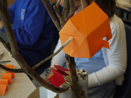 Art week at primary school: cardboard house secured with a stick