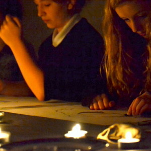 Students draw skulls, on loan from University of Cambridge Museum of Zoology, Cambridge, in candle light