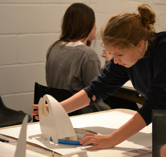 Tilly examining her sculpture of a Turtle Skull - using simple line drawing to explore sculptural form