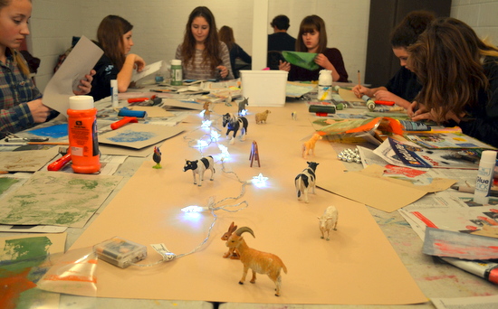 Teenagers draw toy farmyard and woodland animals