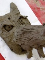 Step 7 – some of the children built up a nose and snarl lines on the muzzle by blending sausages on clay to the surface, then fur texture was added using a fork.