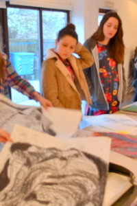 Students at AccessArt's Experimental Drawing Class look through their work