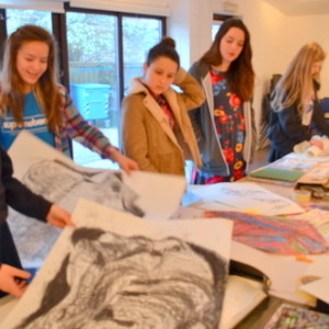 Students at AccessArt's Experimental Drawing Class look through their work