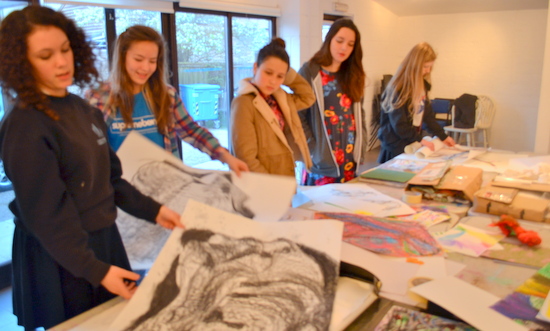 Students at AccessArt's Experimental Drawing Class look through their work