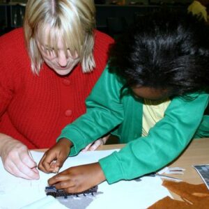 Claire Louise Mather working with a student from St Thomas C of E Primary School, Oldham in Lancashire