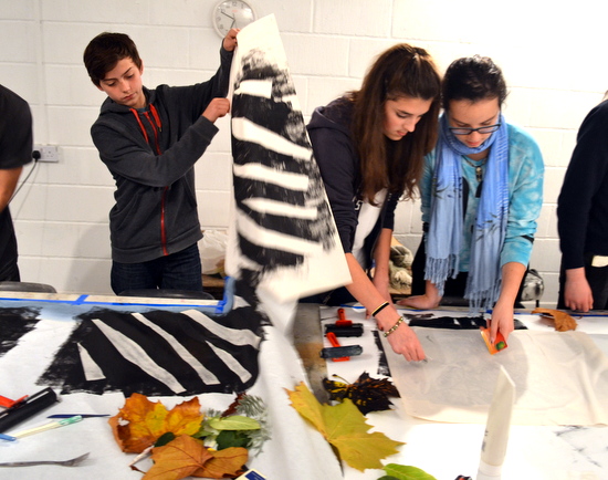 Students working on making a big monotype