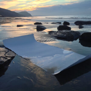 Preparing the canvas: ‘Floating’ the paper on wet sand or in the sea can help to make the surface more receptive. This is tough Khadi paper.