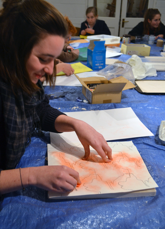 Libby transferring her design from paper to plaster using 'pouncing'