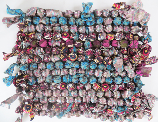 Necklaces tied together and painted with emulsion to form a canvas for future painting Necklaces tied together and painted with emulsion to form a canvas for future painting