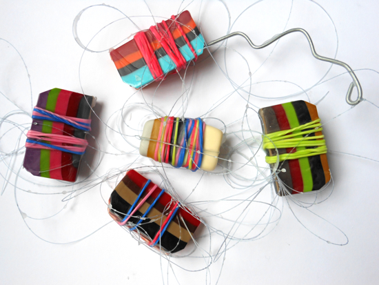 Beads wrapped in loom bands and fishing line, threaded onto shaped wire Beads wrapped in loom bands and fishing line, threaded onto shaped wire