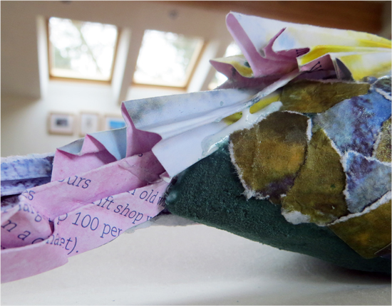 Folded paper added to create tail feathers