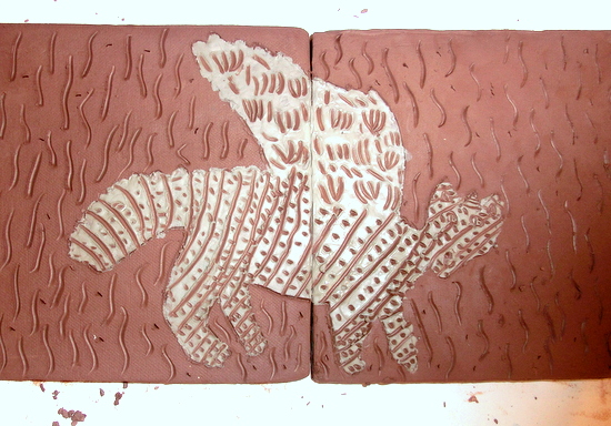 Scraffito onto a clay tile with a coloured slip