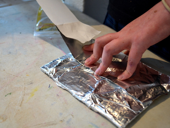 Students used the sticky back aluminium foil to hold the textured design in place on the cardboard