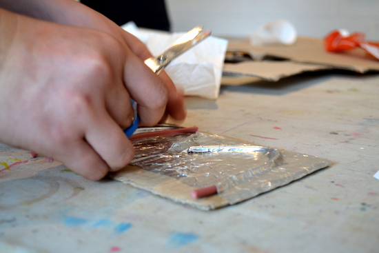 Here a student used thick plasticated string to build up a design on cardboard