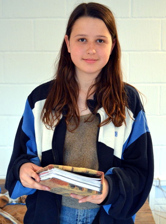 Teenager ready for summer ideas and drawings with her own (thick!) hand-made sketchbook with AccessArt's Experimental Drawing Class