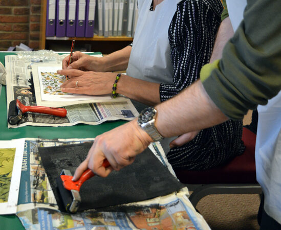 Student at Red2Green preparing a 'plate' for monoprinting