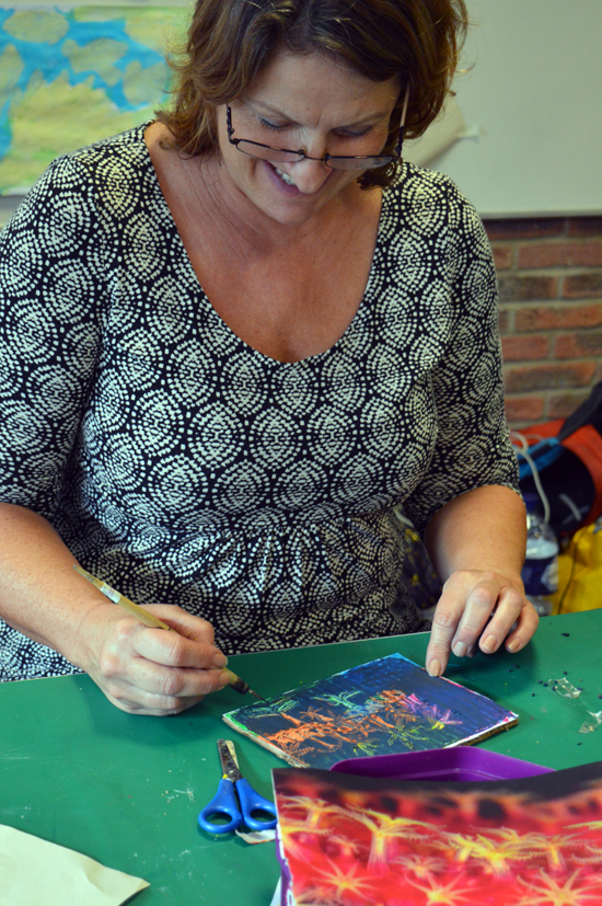 Sally, tutor at Red2Green doing scraffito on a cardboard tablet