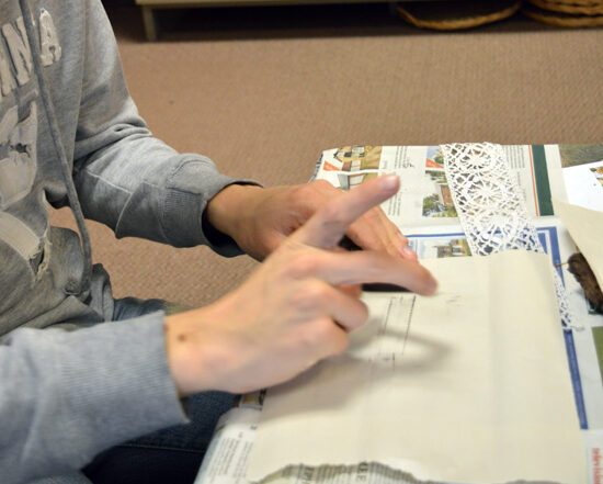 Learner at Red2Green using graphite to take rubbings of lace and natural materials