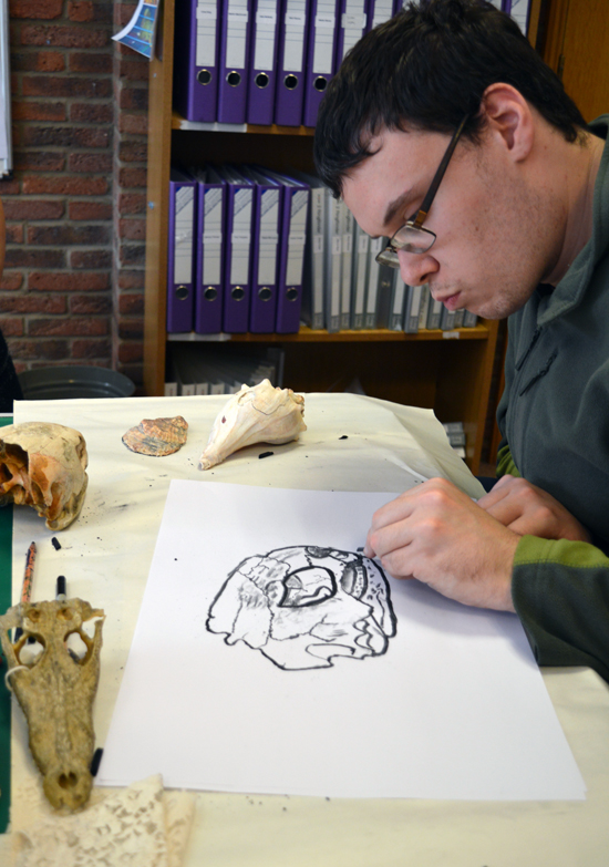 Learner at Red2Green drawing a skull on loan from University of Cambridge Museum of Zoology 