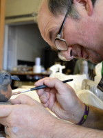 Mark paints his robin's red breast