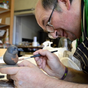 Mark paints his robin's red breast