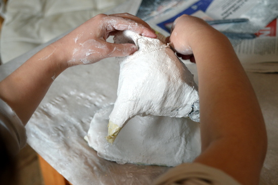 Portia uses her fingers to mould the modroc and create detail